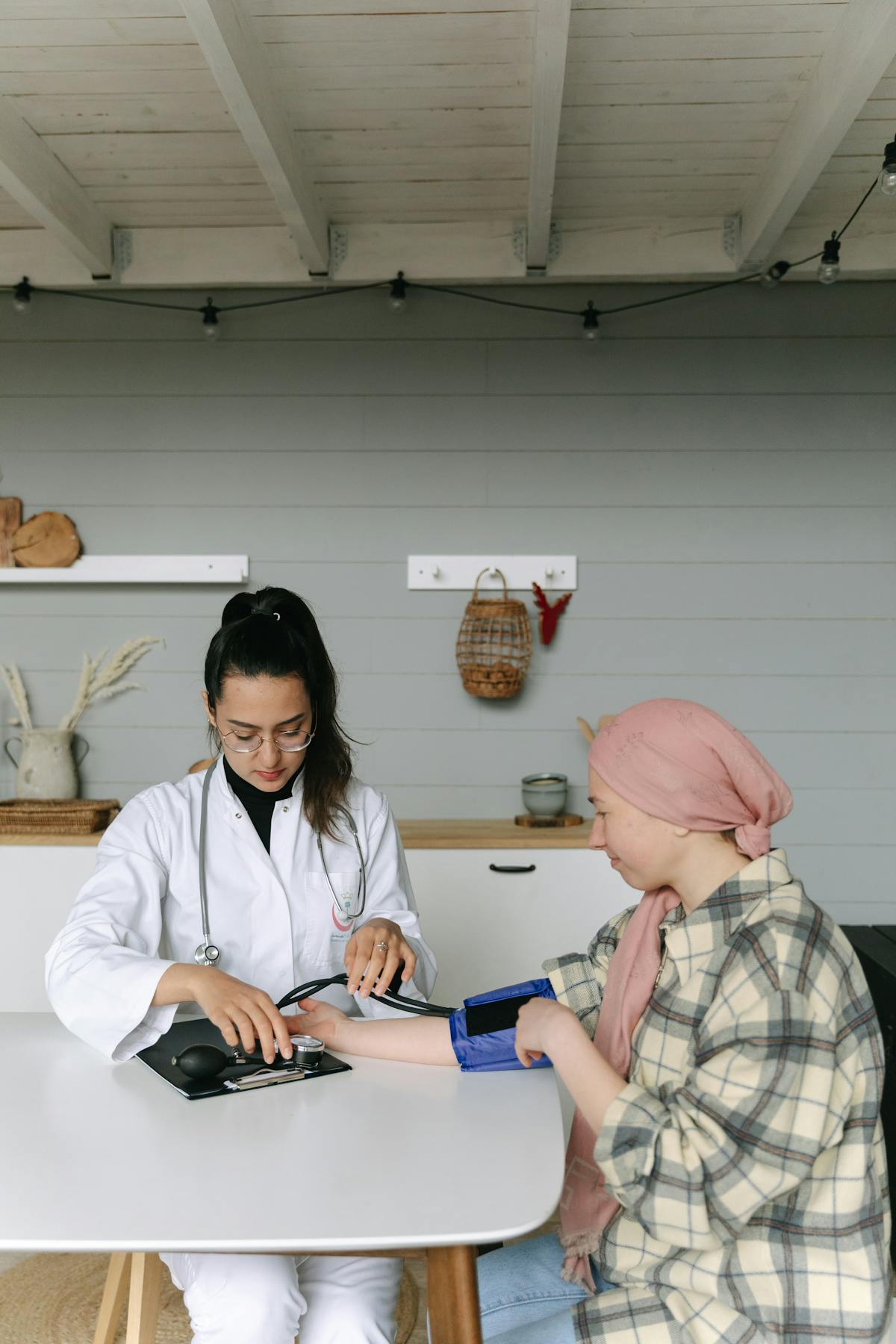 Healthcare professional measuring blood pressure during a home visit