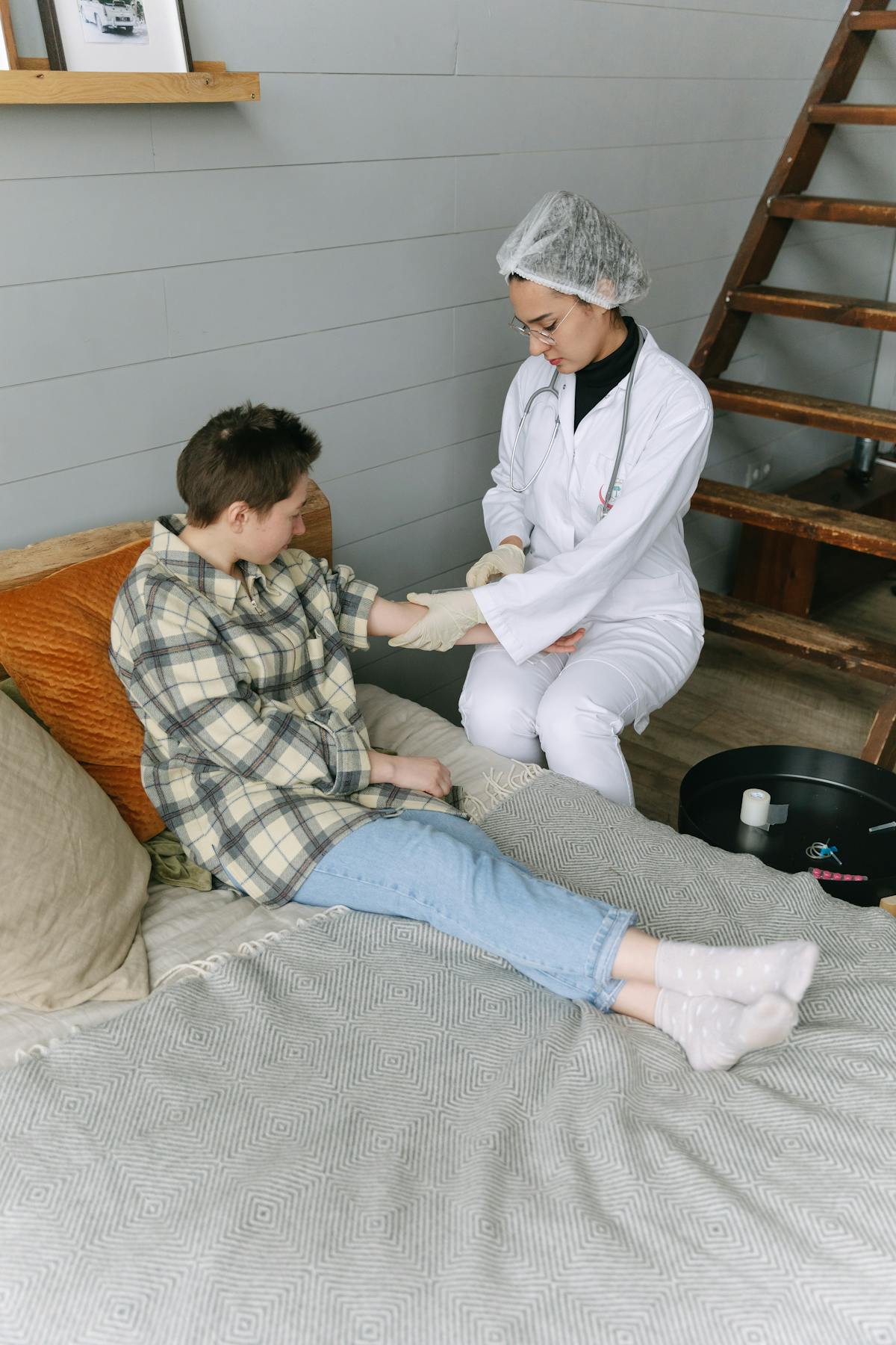 Healthcare professional assisting a patient at home